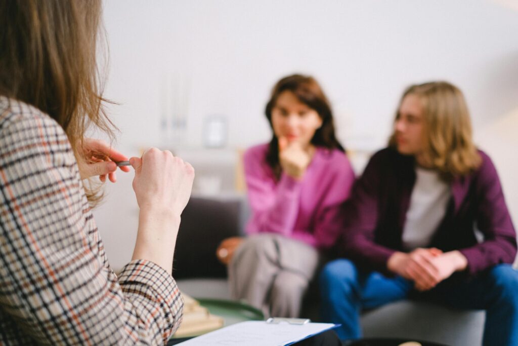 Two spouses meet with a family lawyer in a structured consultation session