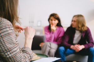 Two spouses meet with a family lawyer in a structured consultation session